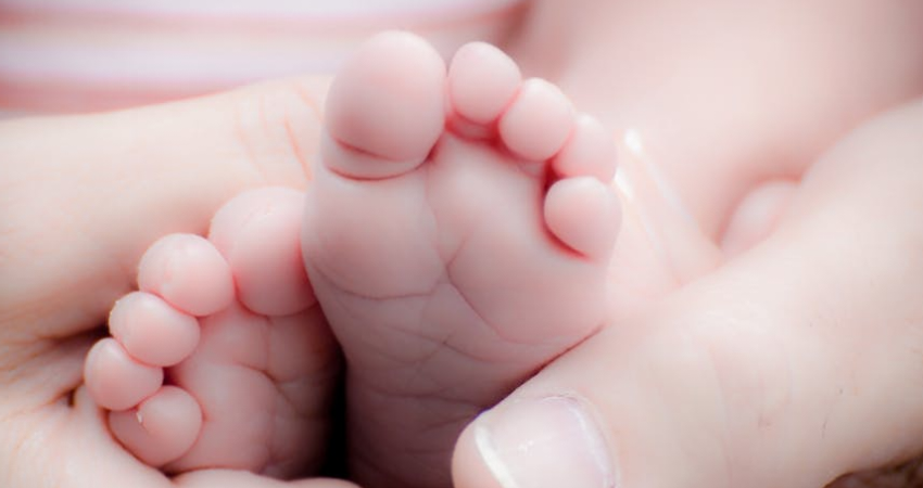 Beautiful photograph of nurse caring for mom post-birth is going viral