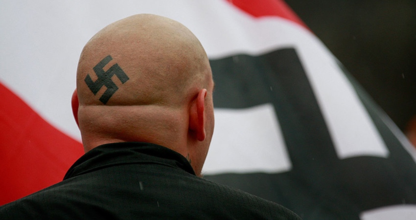 Nazis carrying Swastika flags interrupt Holocaust memorial event chanting 'six million more'