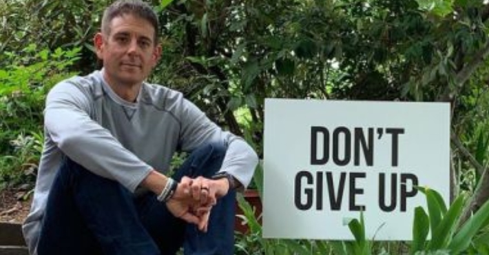 Dad posts 'Never Give Up' signs around town to try lower suicide rates