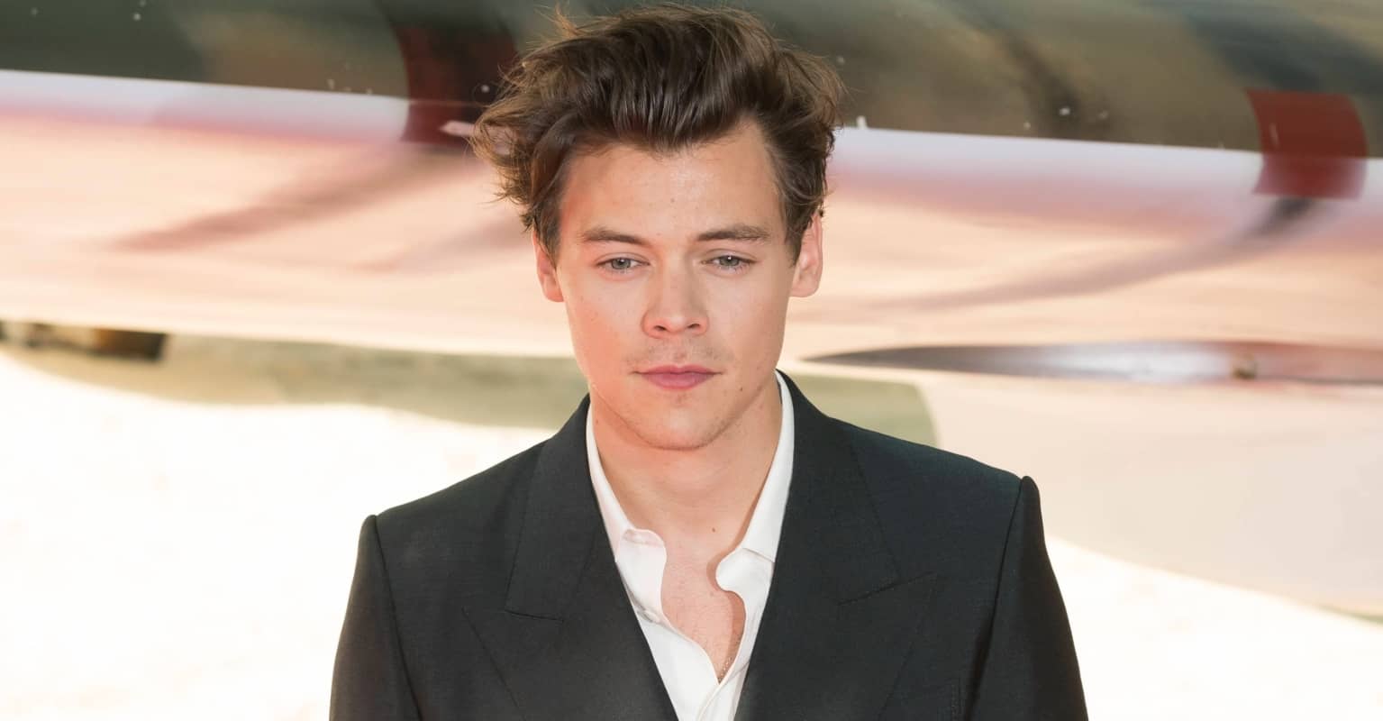 Harry Styles wears dress on cover of Vogue as he becomes first solo male cover star