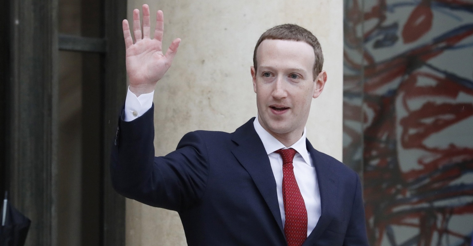 Mark Zuckerberg celebrates July 4th by riding an electric surfboard while holding the US flag