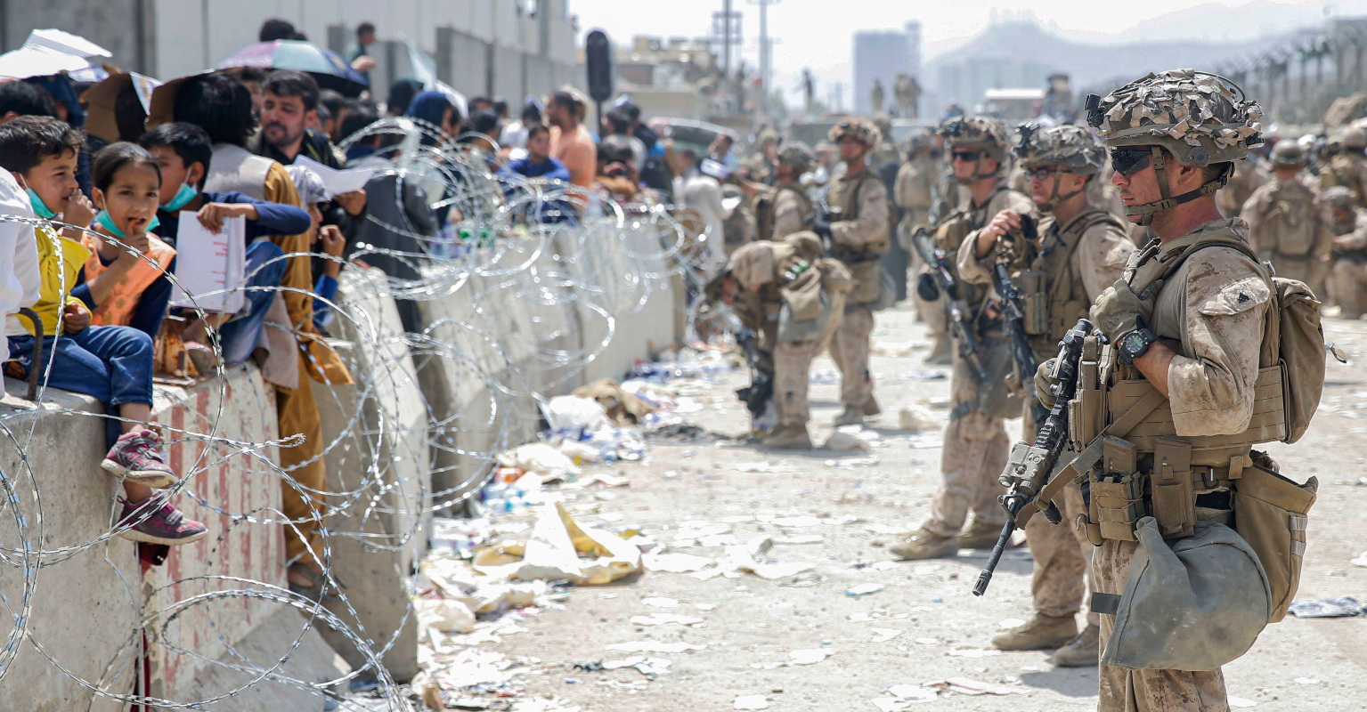 Baby seen being passed over razor wire in Afghanistan has been reunited with father, Department of Defense confirms