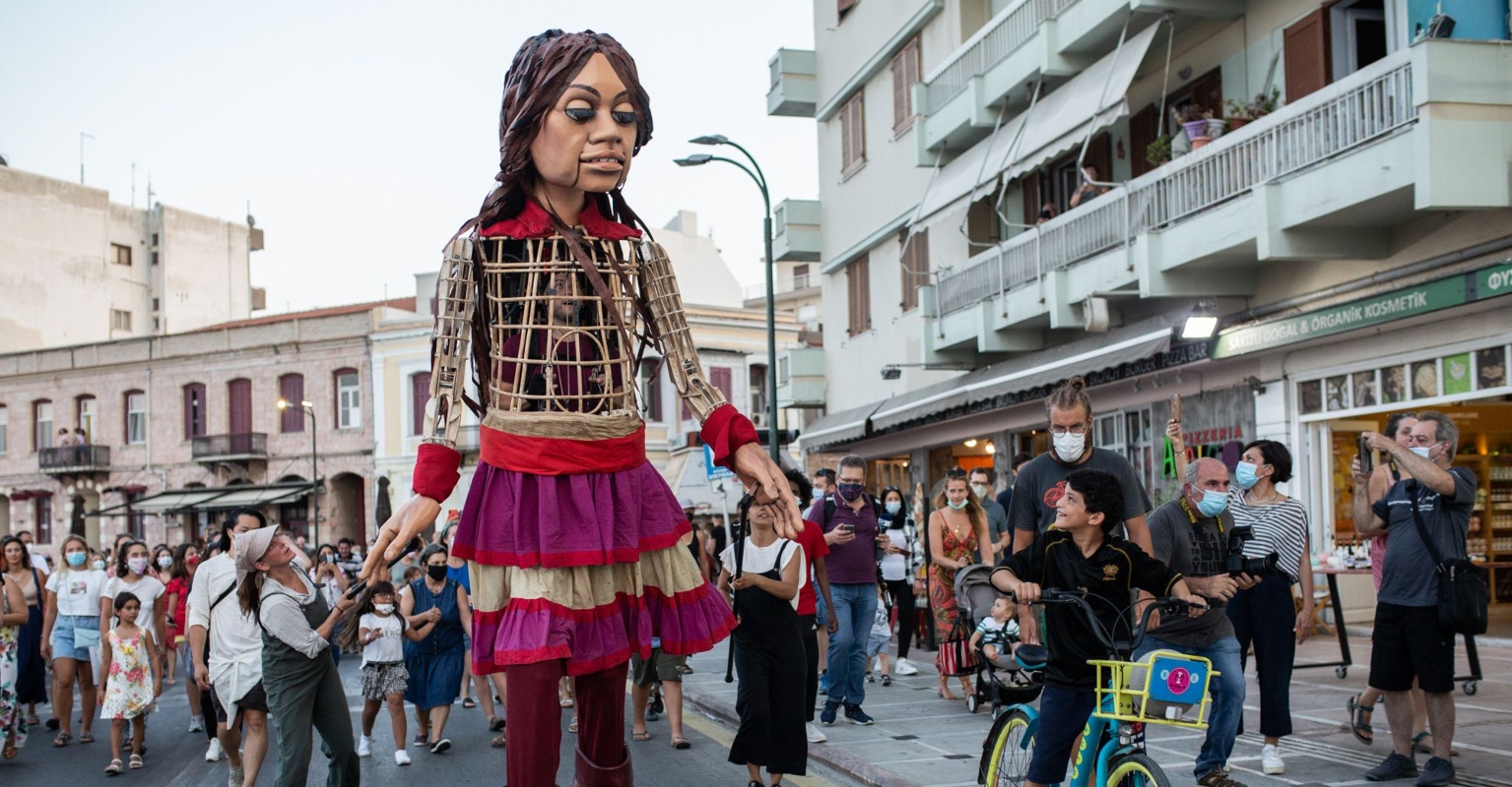 A giant puppet of a young girl is being walked across Europe to highlight the struggles and potential of refugees