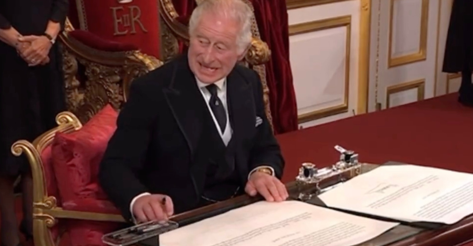 Moment King Charles III frantically motions for pens to be removed as he signs proclamation