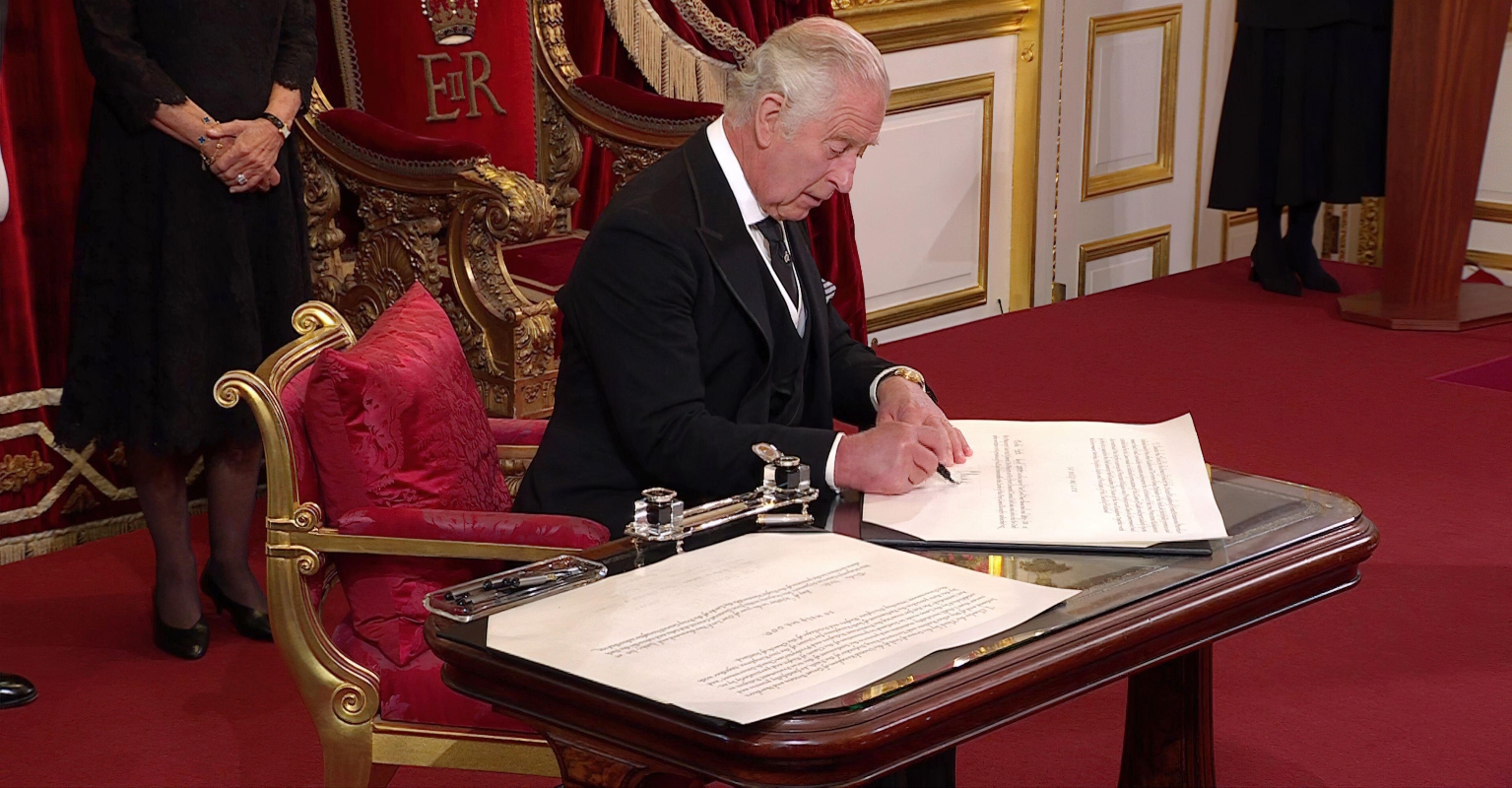 King Charles III laughs as woman hands him a pen, 'just in case'