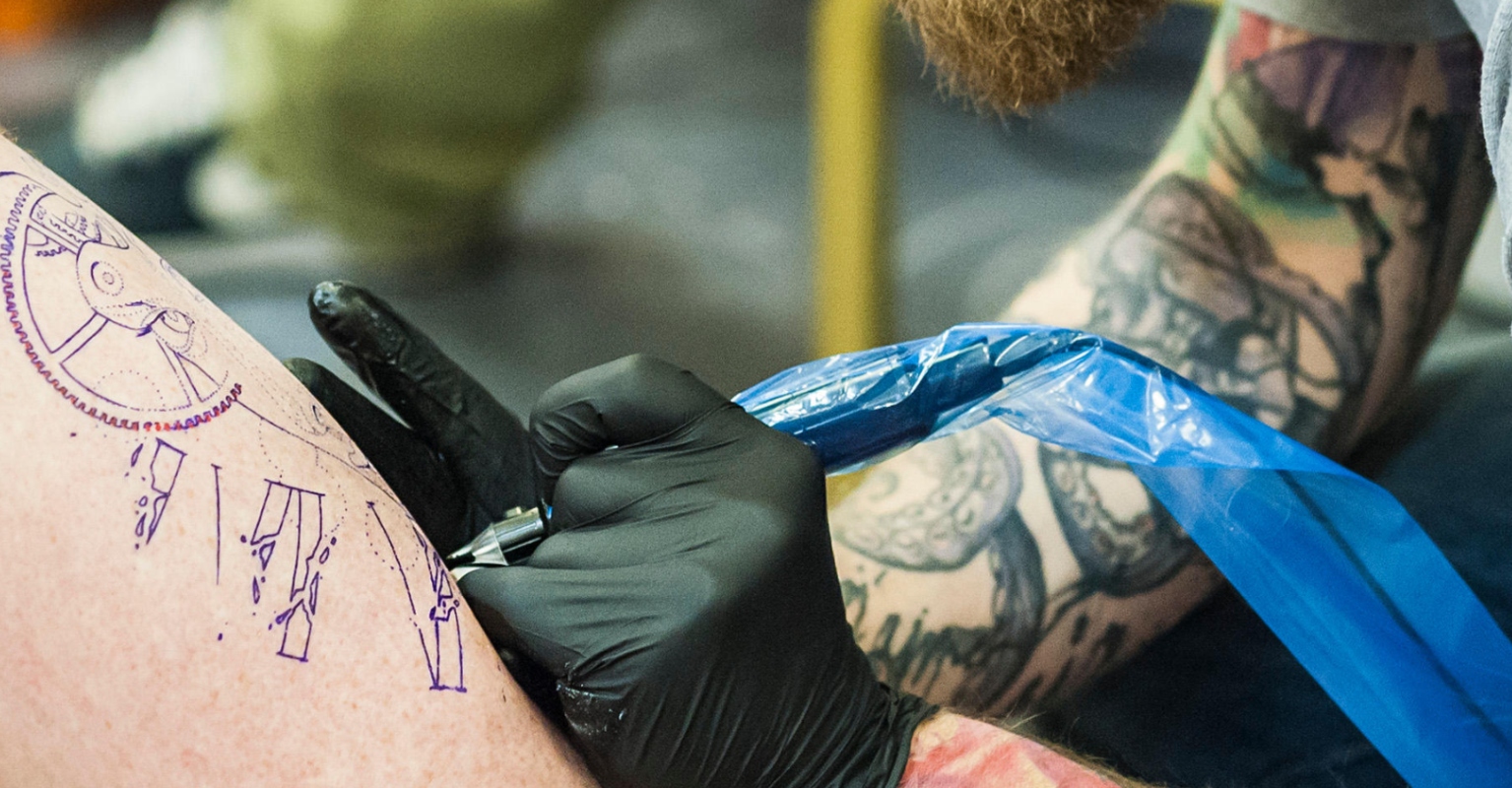 Dad divides social media users after taking his baby son for an airbrush tattoo