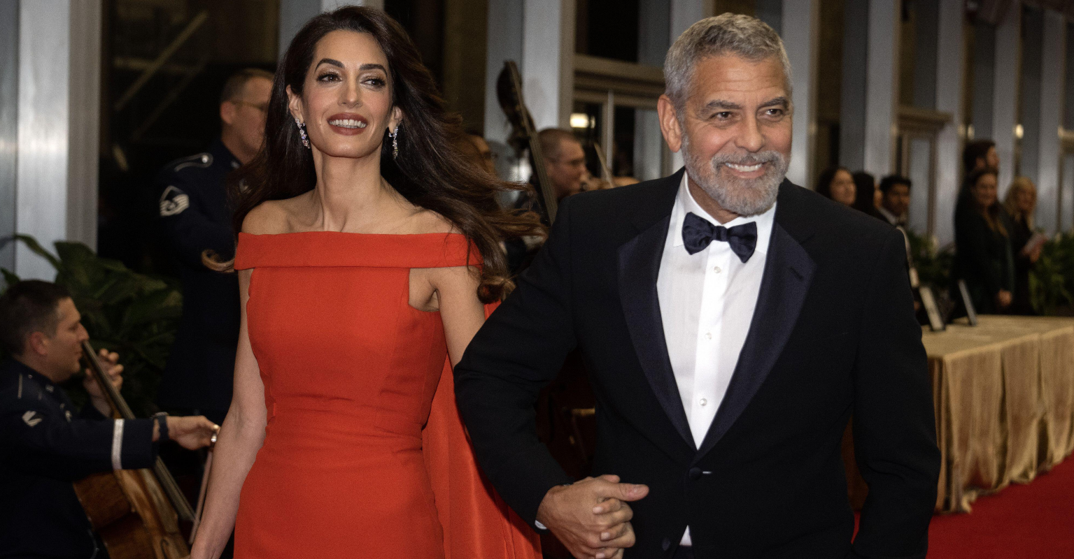George Clooney fixed Amal's dress on the red carpet and the internet is swooning