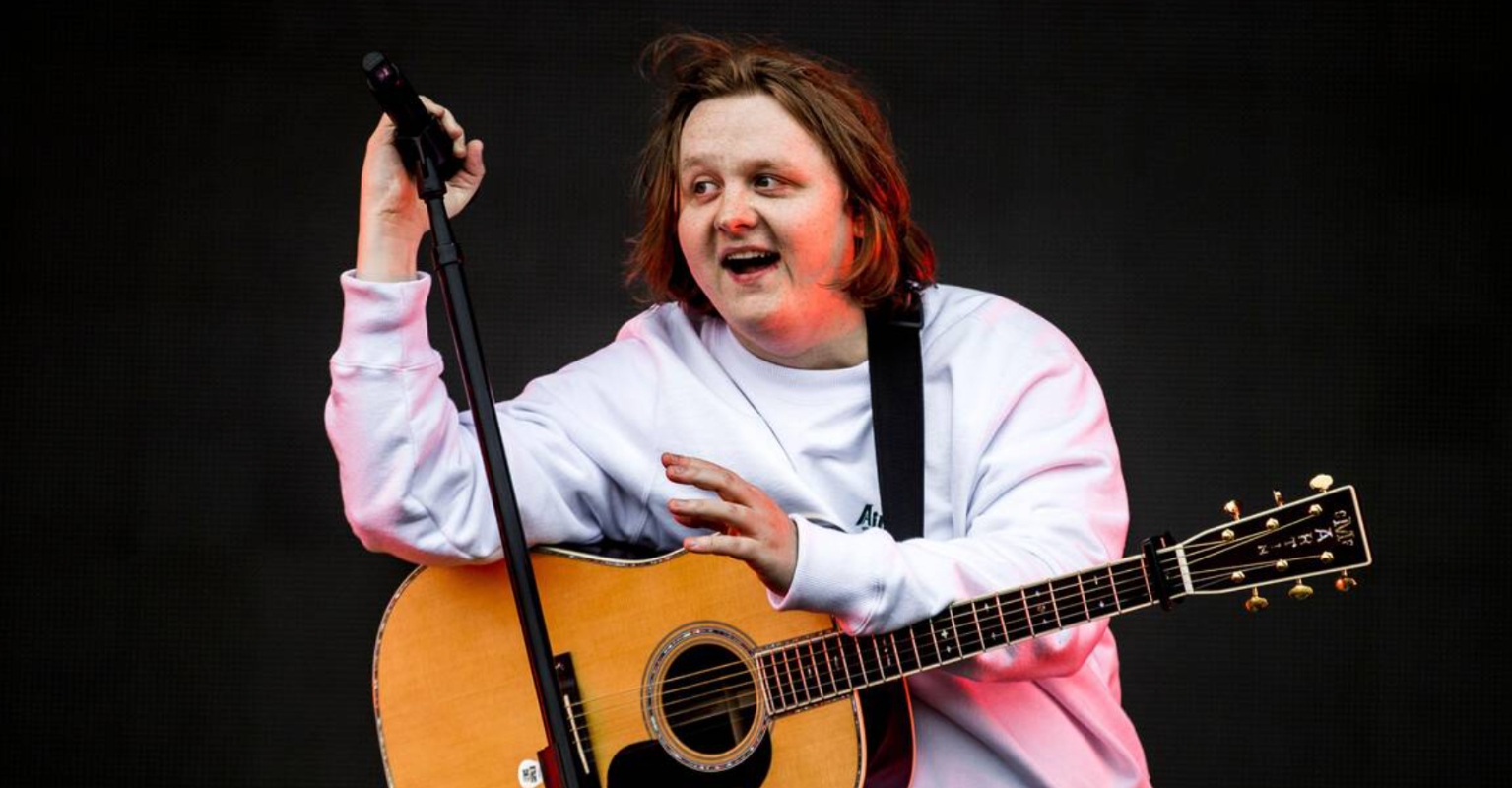 Lewis Capaldi poses alongside statue of himself gifted to him by his former school